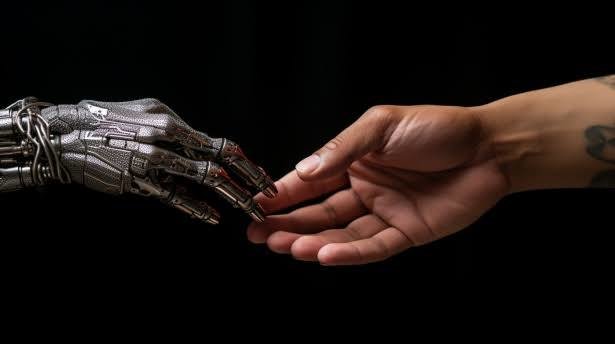 imagem de uma mãorobotica e uma mãohumana se tocando pelos dedos